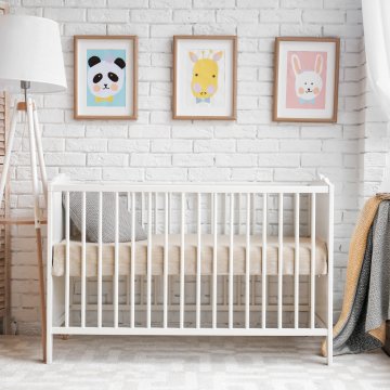 Baby crib side view in a room